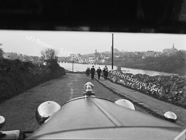 THROUGH WINDSCREEN PEDESTRIANS WALKING FROM TOWN